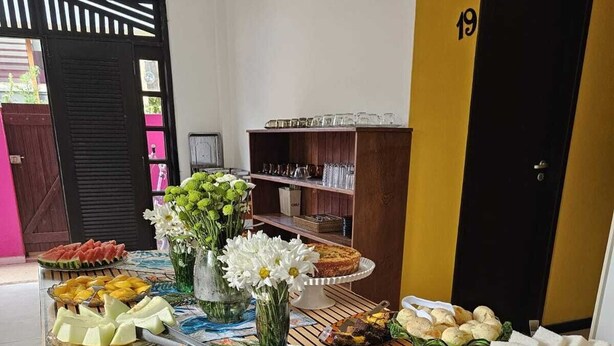 A buffet table with various food items and a cake on a wooden table.