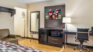 A hotel room with a bed, a desk with a computer, a television, a microwave, and a chair. - Red Roof Inn Chicago - Alsip (Alsip)