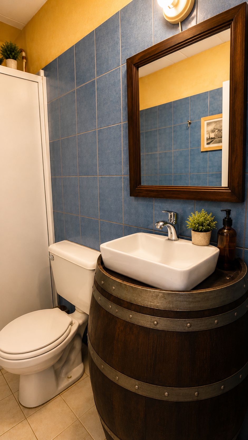 A bathroom with a toilet, a sink on a barrel, and a mirror above the sink.
