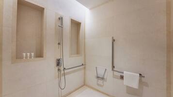 A modern bathroom with a shower, a toilet, and a sink.