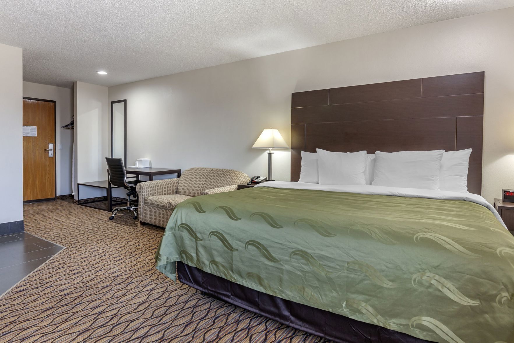 Premium bedding, desk, laptop workspace, blackout drapes