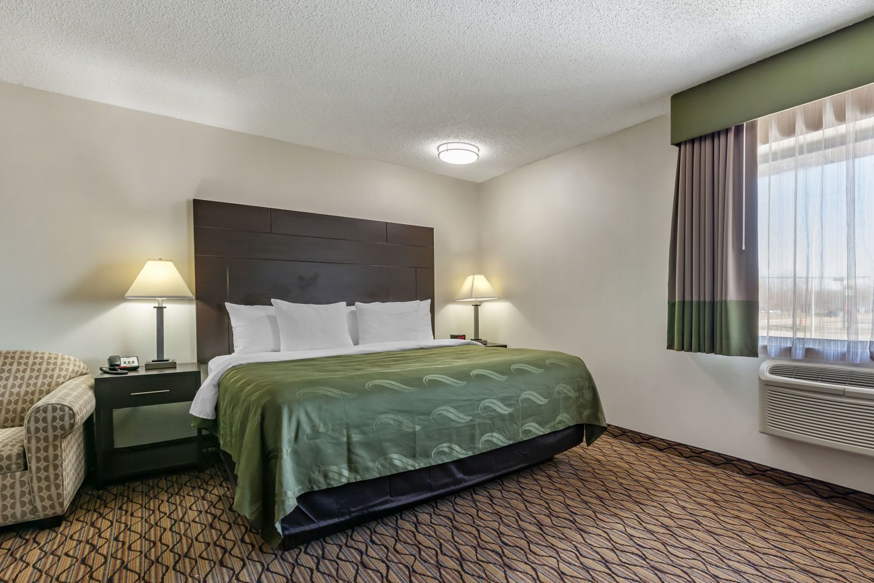 Premium bedding, desk, laptop workspace, blackout drapes
