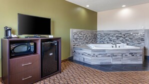 A modern bathroom with a large mirror, a built-in sink, and a shower area. - Quality Inn New London (New London)