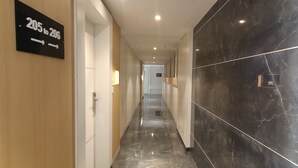 A hotel corridor with a sign indicating room numbers 205 to 206. - Hotel Gopalas Residency (Bhiwandi)