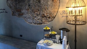 A wall with a rough stone texture and a decorative metal lamp.