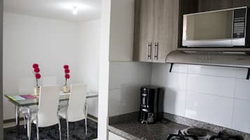 Full-sized fridge, microwave, stovetop, coffee/tea maker