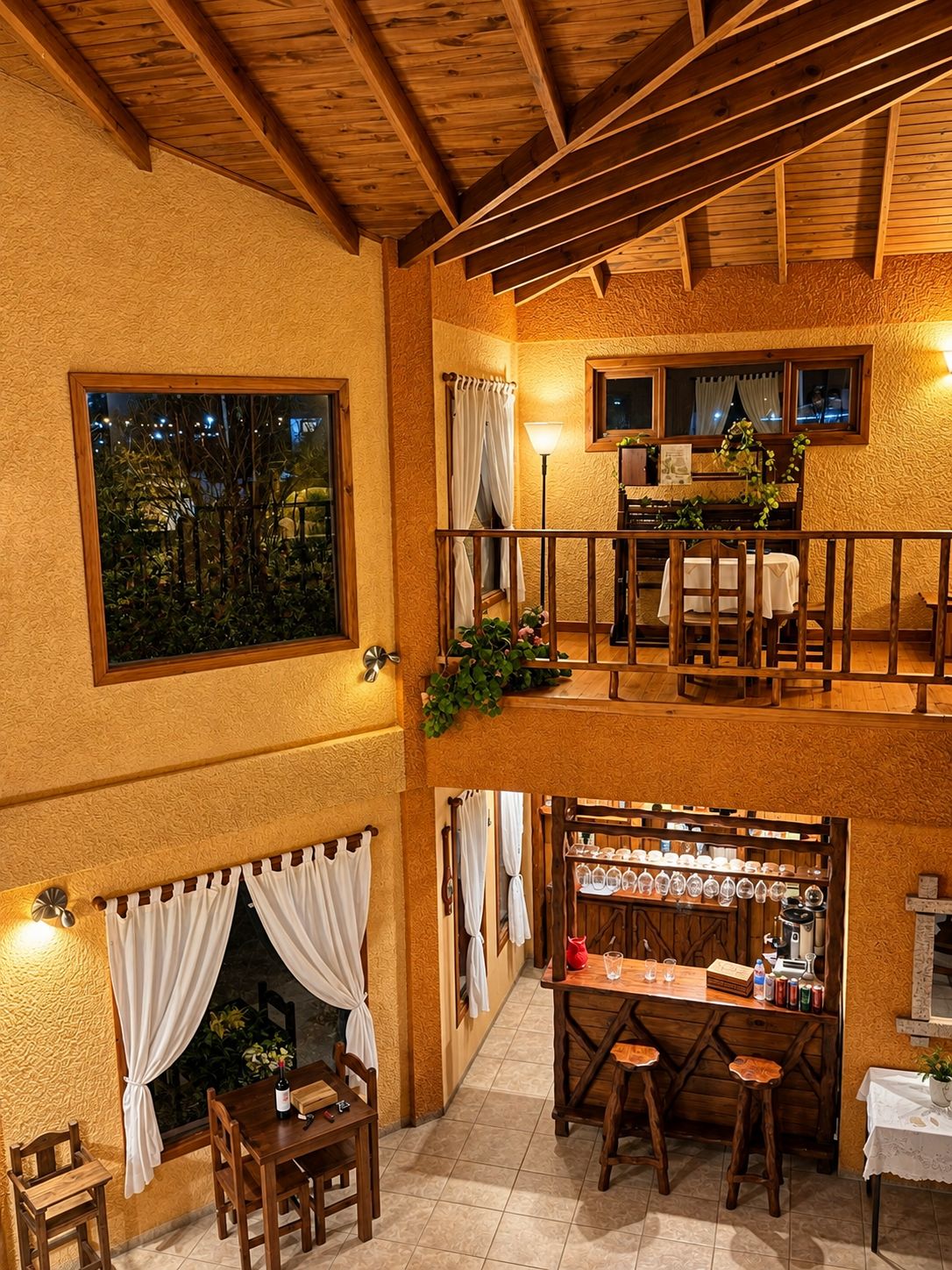 A dining area with a wooden ceiling, a fireplace, and a bar with stools.