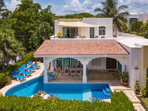 A two-story house with a swimming pool, outdoor seating, and lush greenery. - Casa Miramar by Playa Paradise (Playa del Carmen)