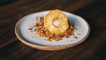 A dessert on a ceramic plate with a wooden background.