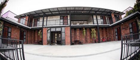 A modern building with a curved roof and brick facade.