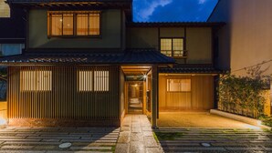 A traditional Japanese house with a tiled roof, a wooden gate, and a stone pathway leading to the entrance. - Kyoto SANARI Konoeden (Kyoto)