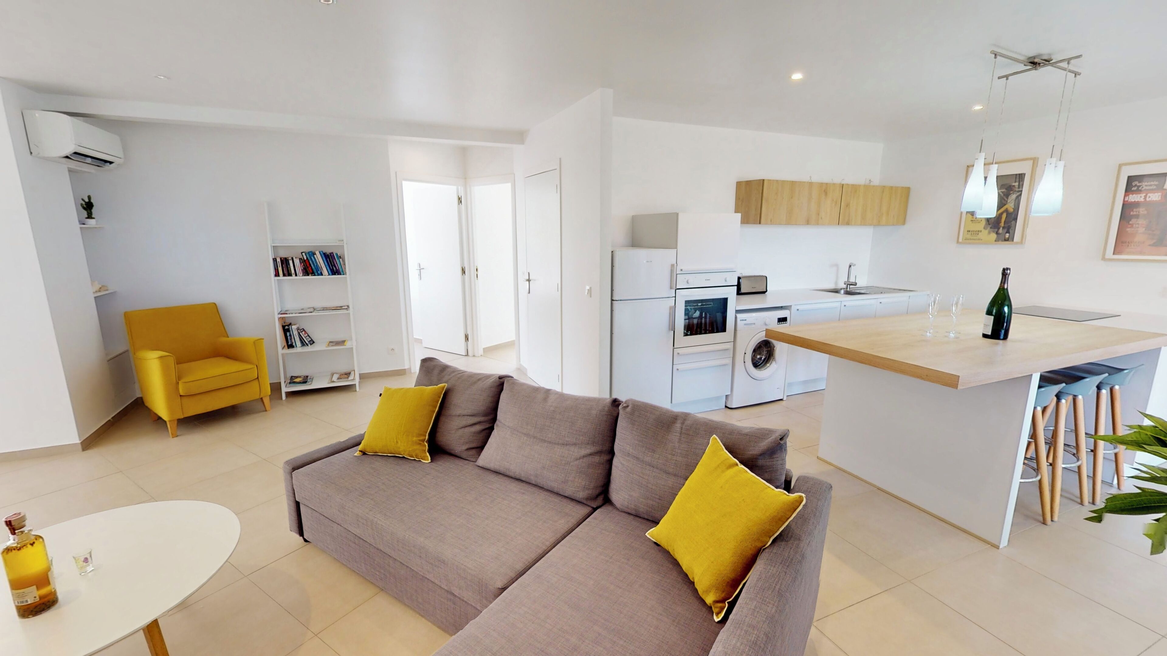 A modern apartment with a living room, kitchen, and dining area.