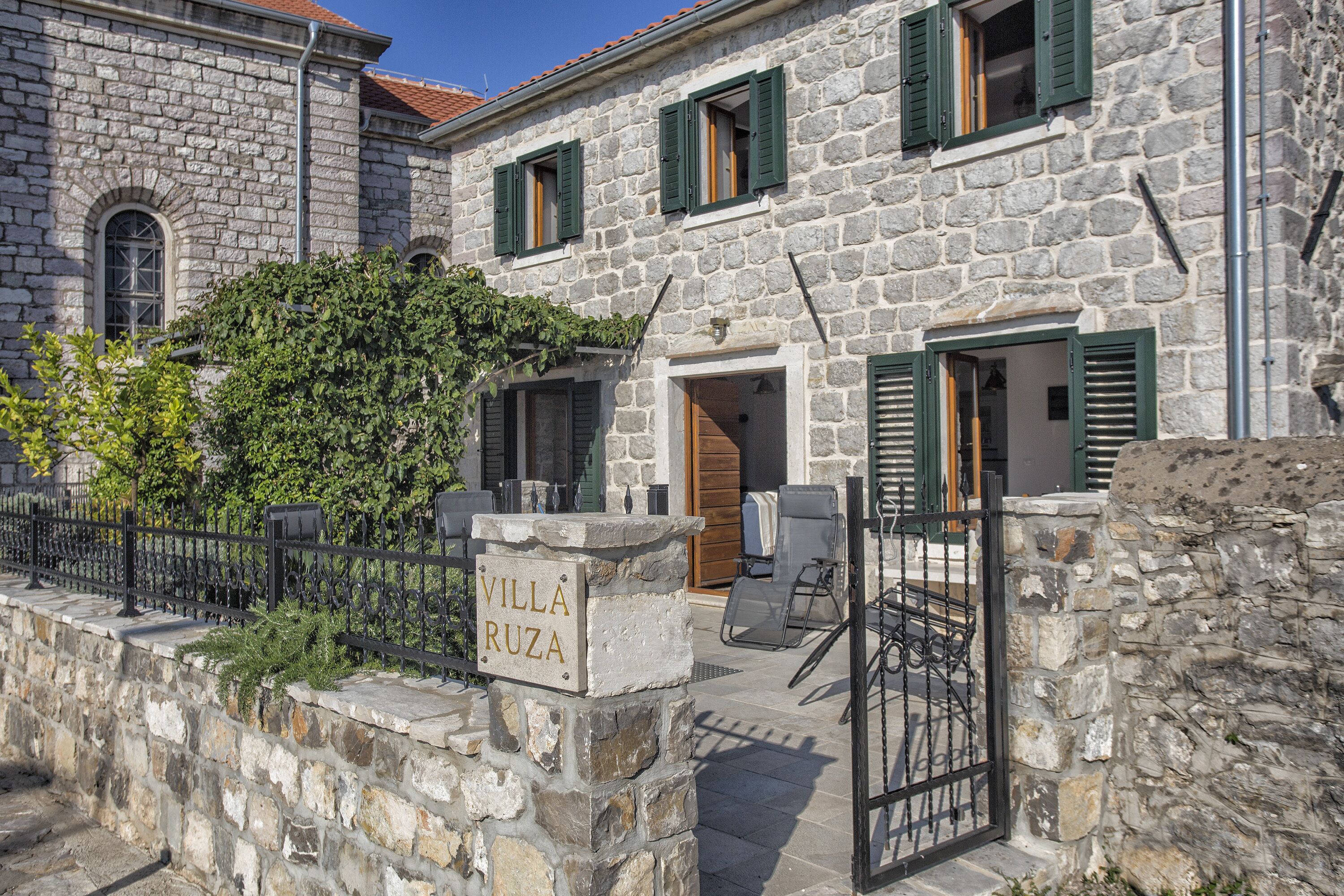 A stone building with a sign reading "Villa Ruzza".