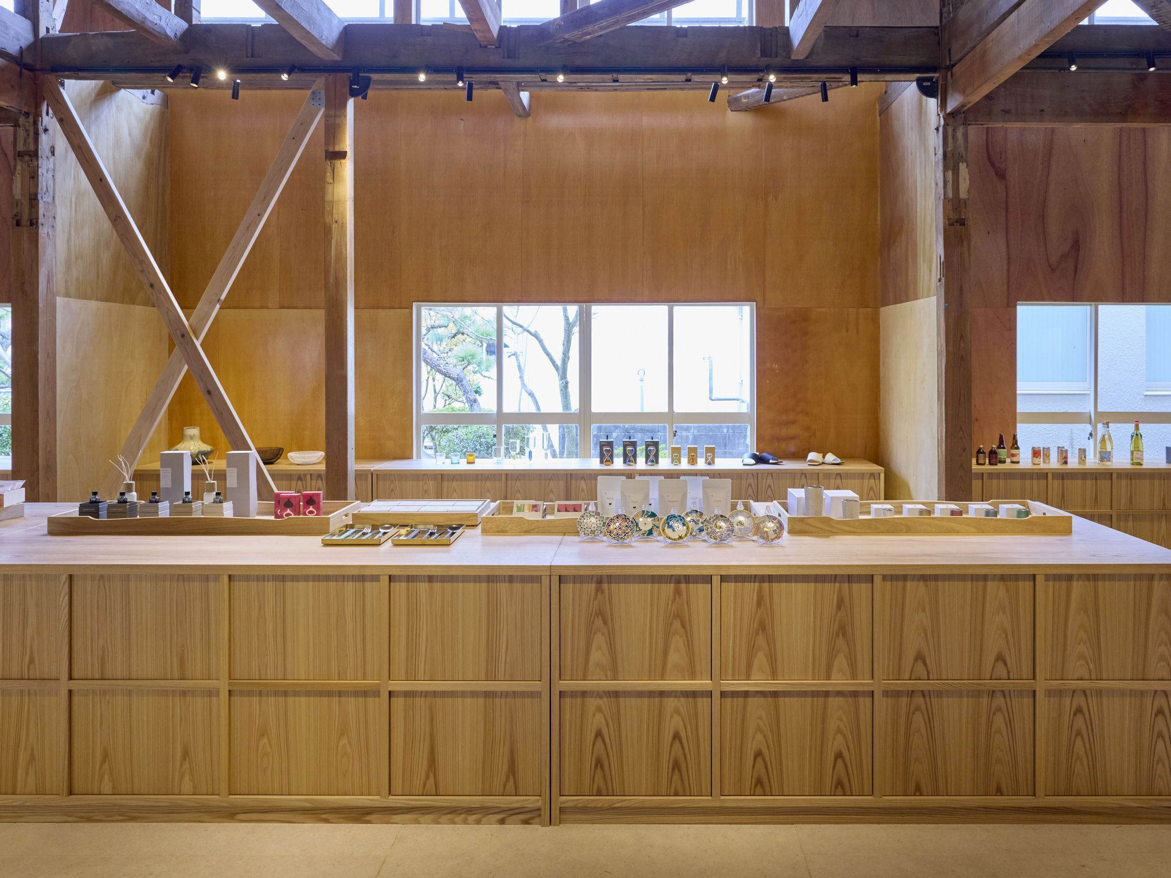 A wooden interior with a long counter displaying various items.