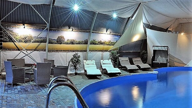 A pool area with lounge chairs and a covered seating area. - Spacious vacation residence for 6 pers. with pool and garden. Sauna - shared use (Stadland-Reitland)