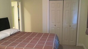 A bedroom with a bed, a wardrobe, and a door leading to another room. - 1 BR located 5 minutes away from St Joseph & Hackensack Hospital. 15 min to NYC  (Paterson)