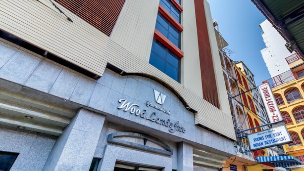 A building with a sign reading "Woodlands Hotel." - Woodlands Inn (Bangkok)