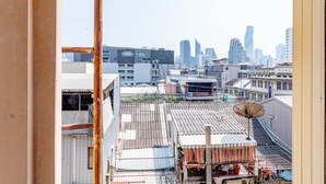 A cityscape with a mix of modern and traditional buildings, including a prominent satellite dish. - Woodlands Inn (Bangkok)