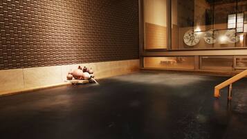 A room with a brick-patterned wall, a large window with decorative elements, and a flat floor.