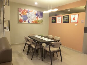 A conference room with a long table, six chairs, and motivational posters on the wall.