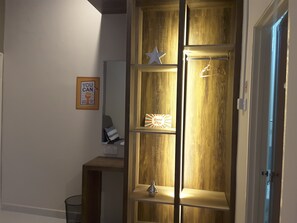 A wooden cabinet with shelves, a star decoration, and a 'Good Day' sign.