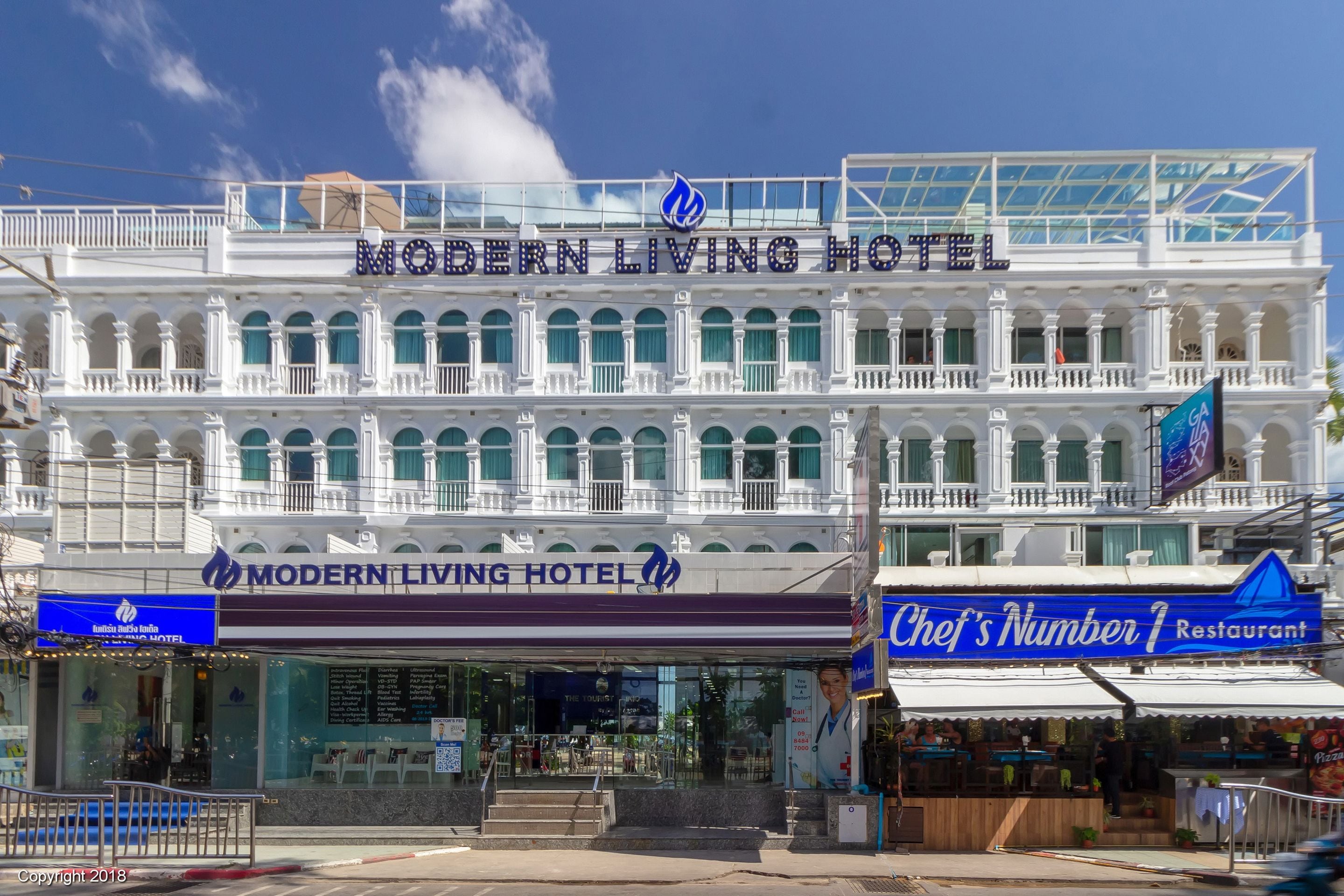 The Modern Living Hotel with a prominent sign, a restaurant named Chef's Number 1, and a view of the street.