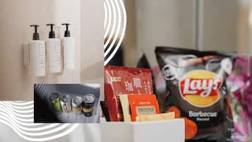 Toiletries, snacks, and beverages on a counter.