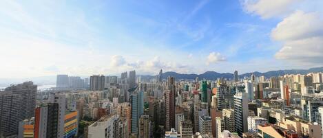 A densely packed urban skyline with high-rise buildings and a clear sky.