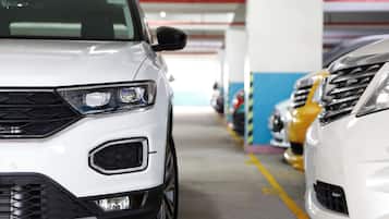 A parking garage with cars parked in rows.