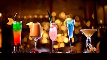 A bar setting with various colorful cocktails.