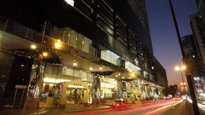 A modern hotel with a glass facade and a prominent entrance. - B P International (Kowloon)