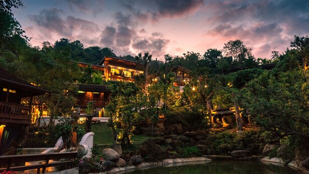 A traditional Japanese-style building with a koi pond and lush greenery. - Chantra Khiri Chalet Chiang Mai (Hang Dong)