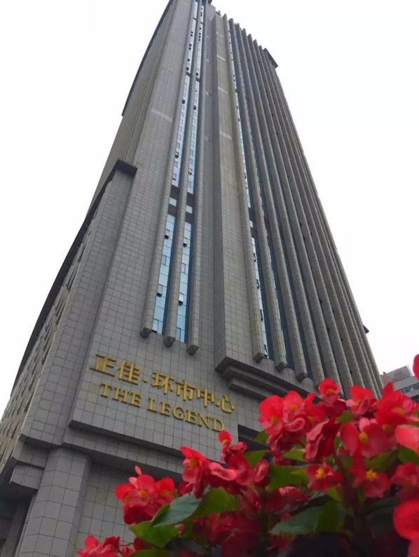 A tall building with a grid-like facade and a sign that reads "THE LEGEND". - Mahattan Apartment - Free Shuttle Bus for Canton Fair (Guangzhou)