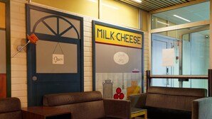A seating area with a sign that reads "MILK CHEESE" and another sign that says "Open". - Laitilan Kievari (Laitila)