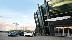 A modern building with a large glass facade and a prominent "PAGANI" sign.