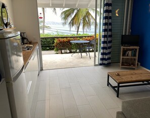 Panoramic Apartment, 1 Bedroom, Terrace, Bay View | Living area | 32-inch flat-screen TV with satellite channels, TV, toys - Habitation Desrosiers (Trois-Ilets)