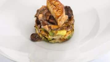 A dish with various ingredients on a white plate.