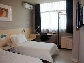 A hotel room with two beds, a desk with a chair, a TV, and a window with curtains. - Jinjiang Inn Yongkang City (Jinhua)