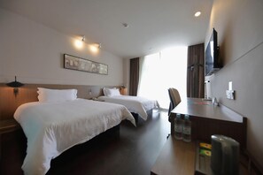 A hotel room with two beds, a desk, a television, and a window with curtains. - Jinjiang Inn Select (Shanghai International Tourist Resort Huinan Wild Animal Park) (Shanghai)