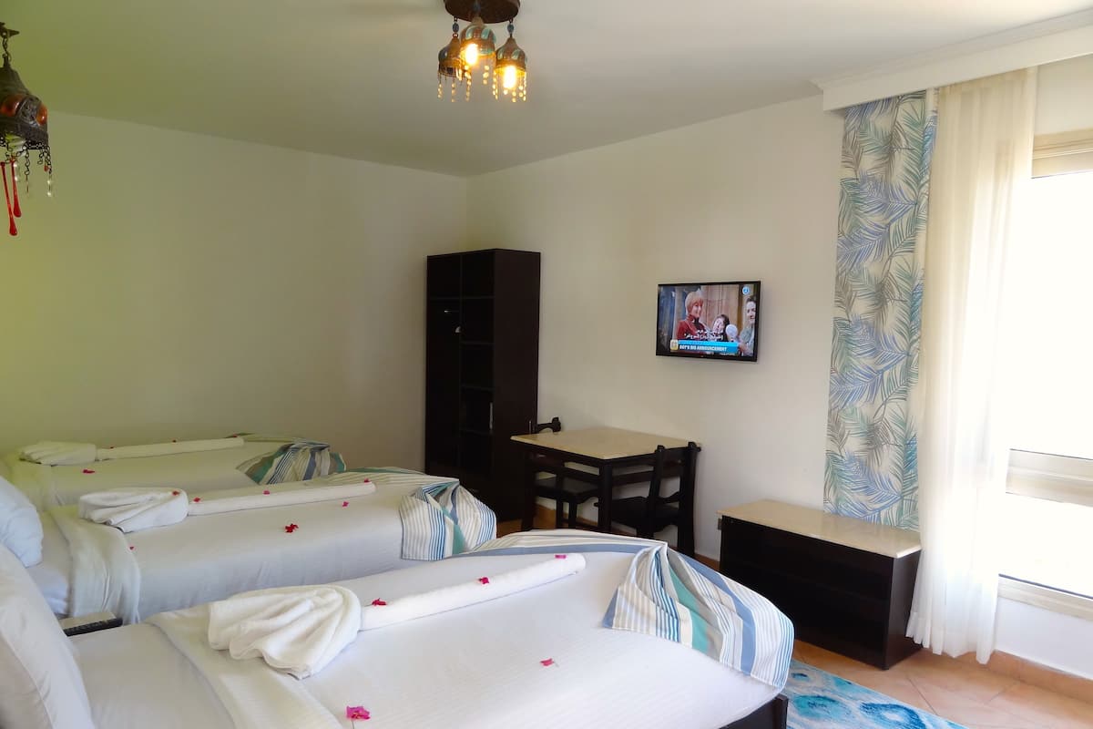 Economy Triple Room | 1 bedroom, in-room safe, iron/ironing board, bed sheets