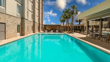 Outdoor pool, open 10:00 AM to 10 PM, pool umbrellas, pool loungers