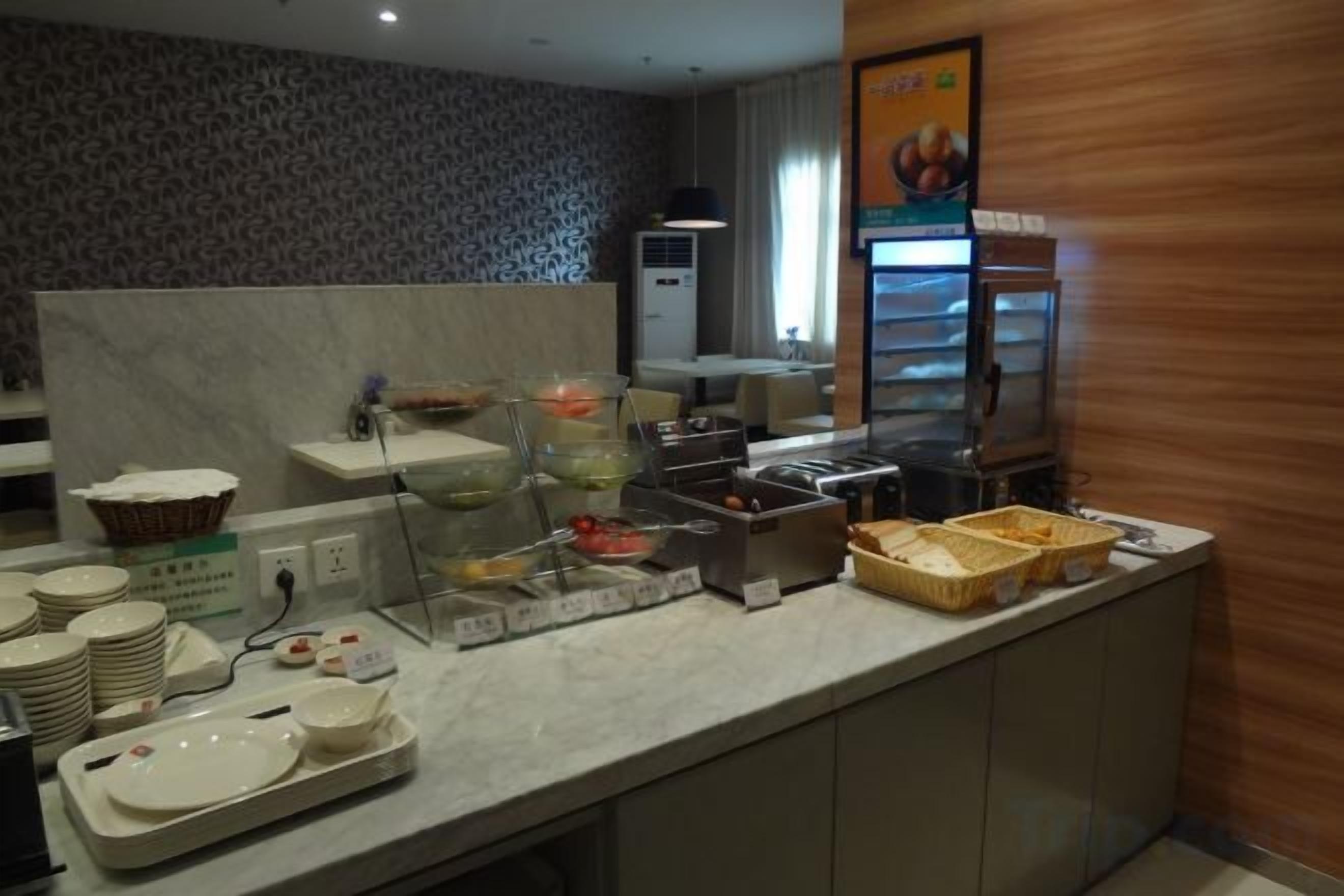 A buffet setup with various food containers and serving dishes.