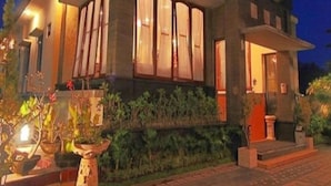 A two-story house with large windows, a front porch, and potted plants. - Puri Nusa Indah (Denpasar)