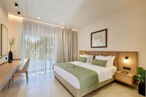 A modern hotel room with a large bed, a desk, and a view of the outdoors. - Inea Studio (Chania)