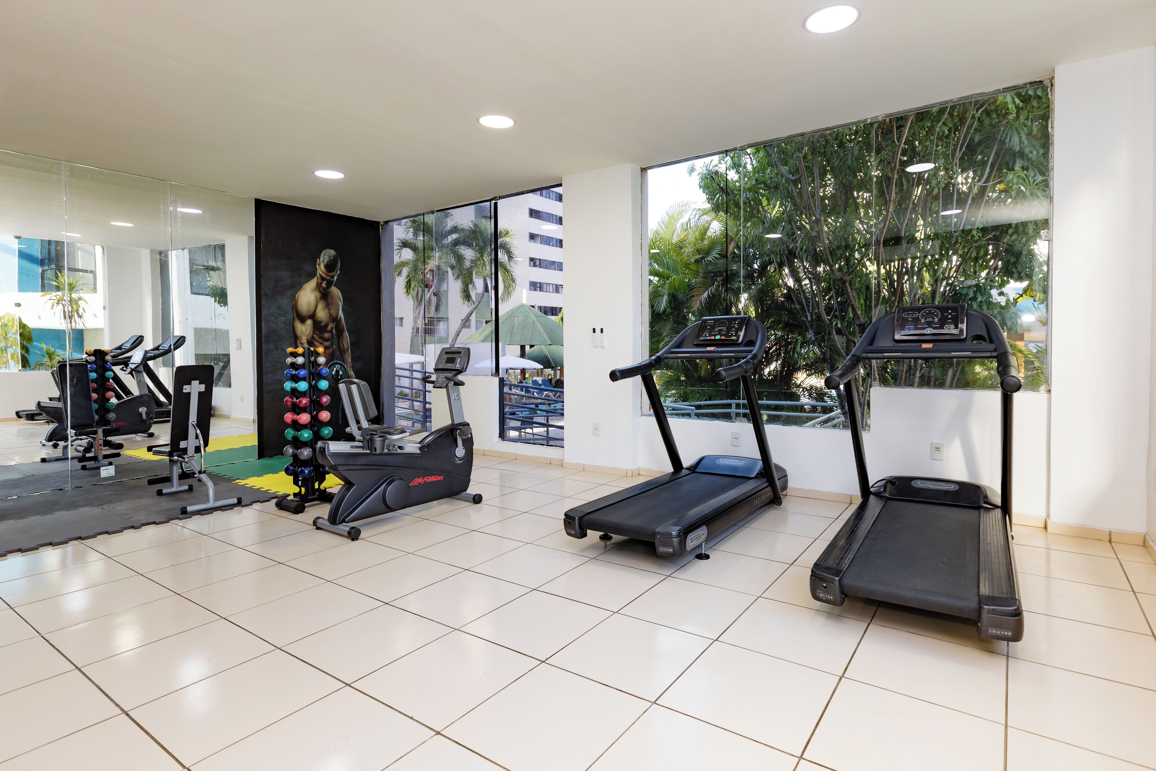 A gym with treadmills, a stationary bike, and a weight machine.