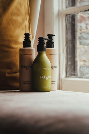 A bottle of Pelegrim skincare products on a windowsill. - The Five Bells Inn Brabourne (Ashford)