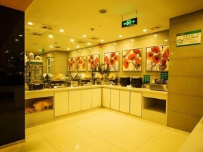 A hotel lobby with a self-service breakfast area, a reception desk, and a sign indicating the exit. - Jinjiang Inn Chuzhou Langya Street (Chuzhou)