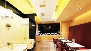 A modern restaurant interior with a long counter, multiple tables, and chairs. - Jinjiang Hotel (Tianjin West Station Xianyang Road Subway Station) (Tianjin)