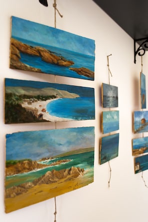 A series of paintings depicting coastal scenes. - Vistazzurra B&B (Ancona)