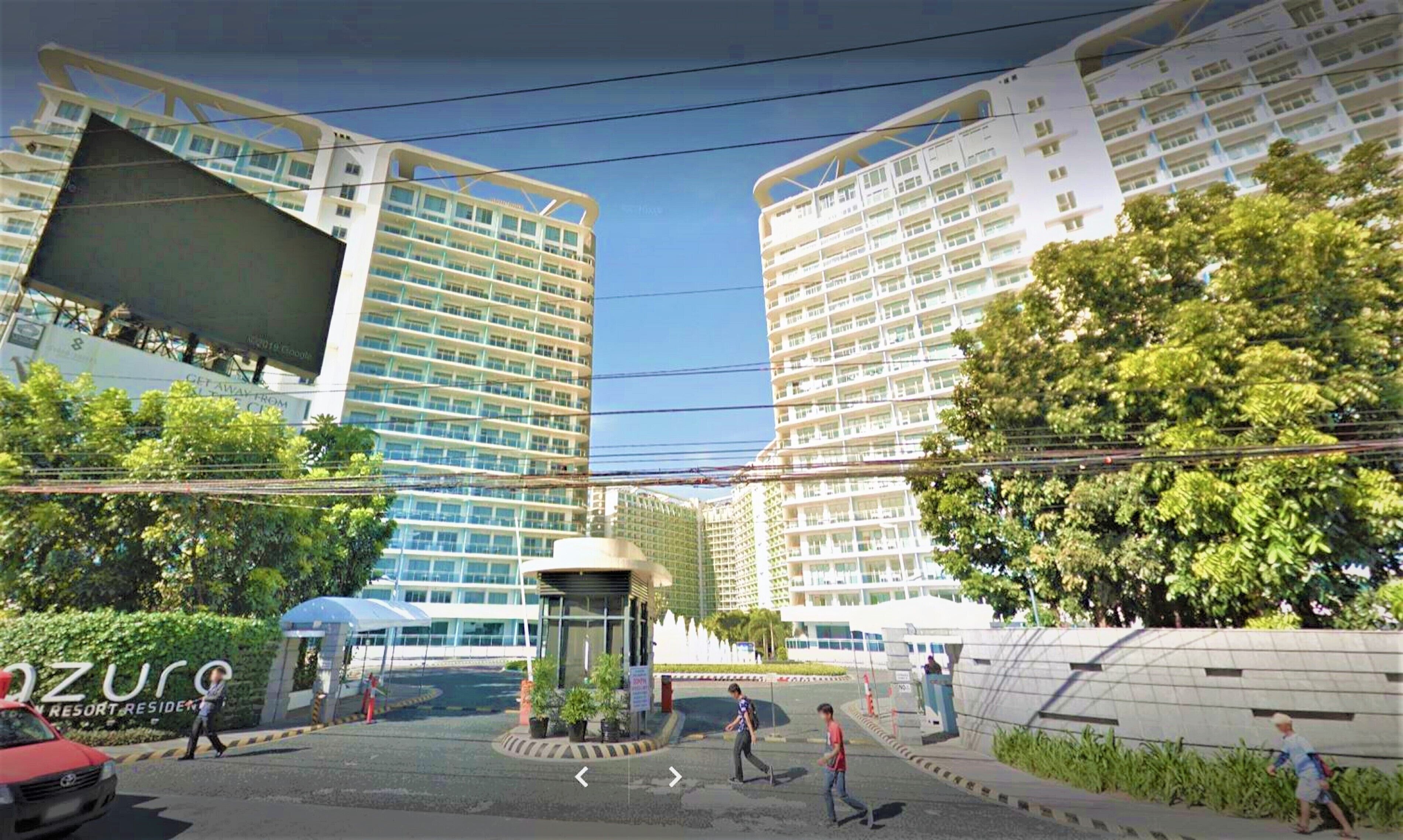 A modern residential complex with multiple high-rise buildings, a central courtyard, and greenery.